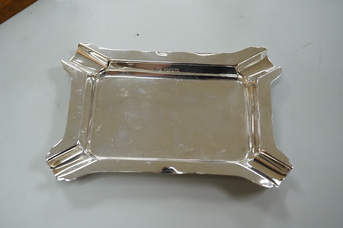 A collection of silver or white metal to include a miniature model dhal, ashtray, scent bottle and toilet jar, together with a metal Ronson table lighter.